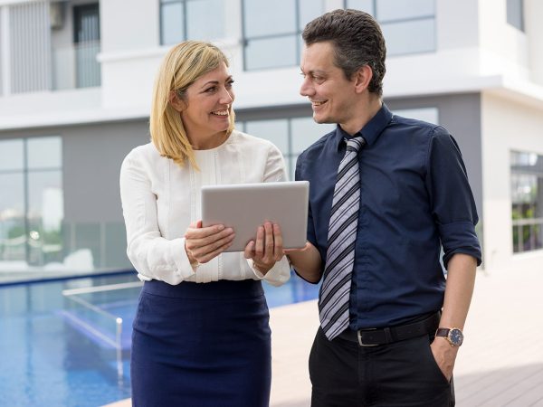 man and woman outside with tablet